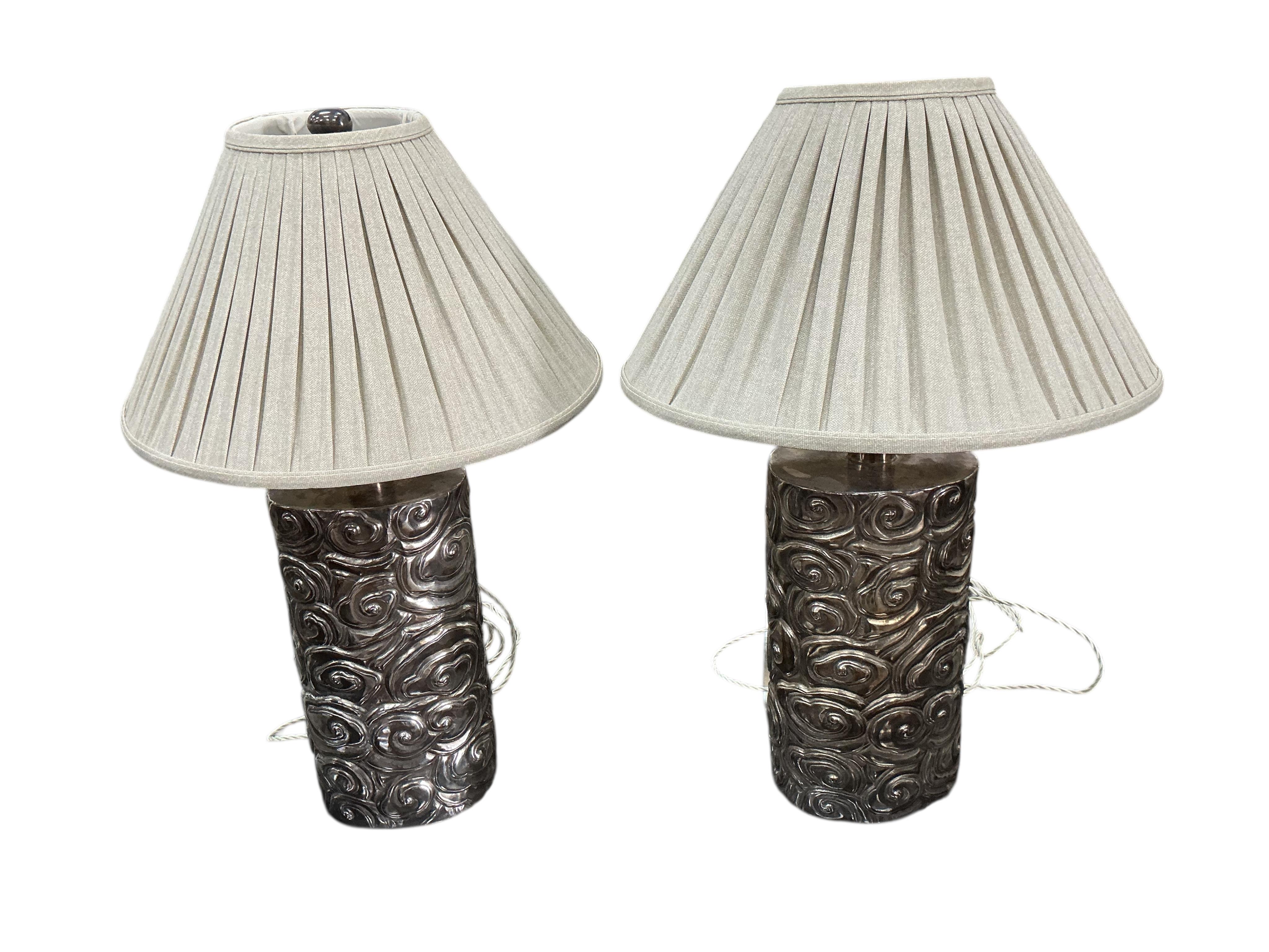 A pair of Robert Kuo Collection McGuire repousse table lamps with quilted shades, height 78cm